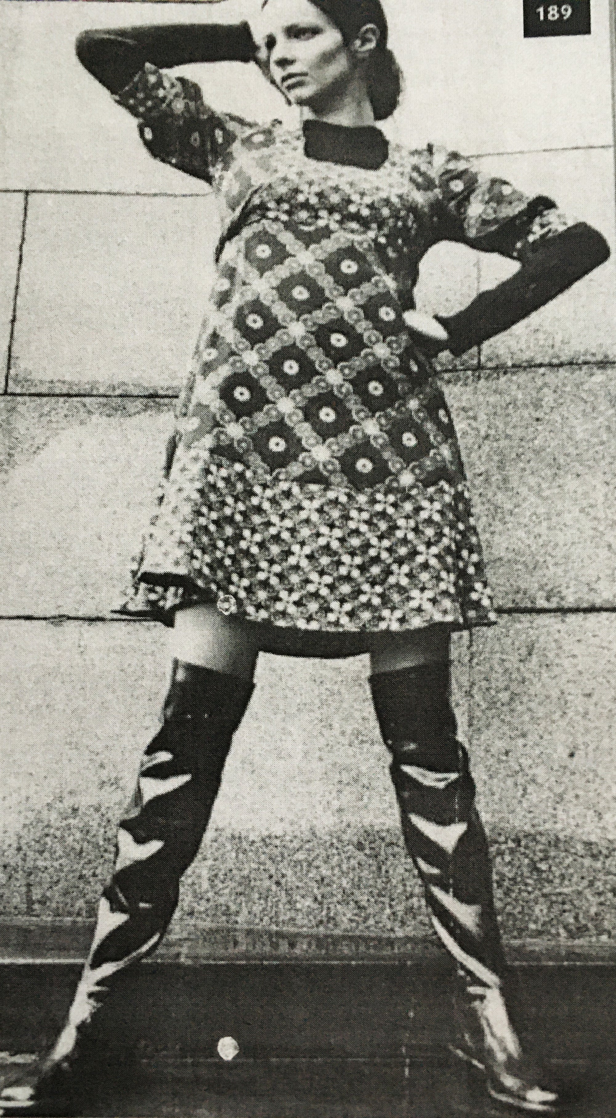 Vintage black-and-white photo of a model in a bold patterned mini dress and iconic ACQUO of Sweden high-shine over-the-knee boots – capturing retro Swedish fashion with timeless attitude and statement style