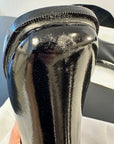 Close-up of the heel and toe area of an ACQUO of Sweden black rubber boot, showing a visible scuff mark on the toe and textured surface on the heel for detailed quality inspection
