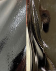 Close-up of ACQUO of Sweden’s glossy black rubber boots displaying handcrafted surface structure and visible material lines, emphasizing premium quality and artisanal boot manufacturing