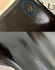 Detailed image of ACQUO of Sweden over-the-knee black rubber boots showing surface imperfections, including a visible scuff mark on the shaft and subtle textural irregularities for product inspection or quality control