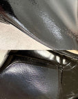Close-up of ACQUO of Sweden black rubber boot surface with visible irregular texture, creases, and small imperfections in the material