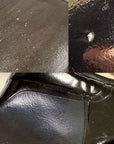 Close-up collage of ACQUO of Sweden black shiny rubber boots showing surface imperfections and material defects