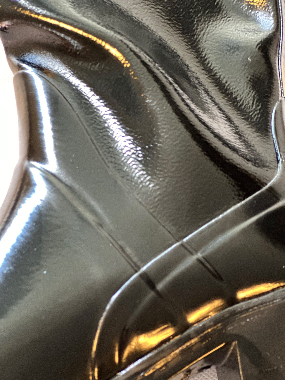 Close-up of the high-gloss finish and sculpted detailing on ACQUO of Sweden's black rubber boots, highlighting the premium craftsmanship and texture of the iconic Swedish boot design."