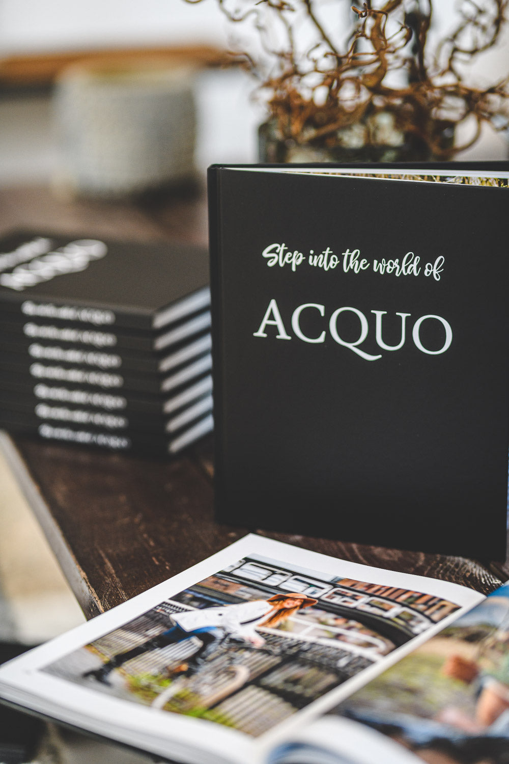 Elegant hardcover fashion book titled "Step into the world of ACQUO" on display, showcasing the legacy and style of ACQUO of Sweden's iconic boots.