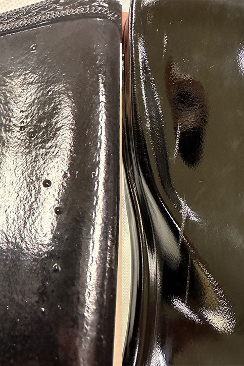 Detail view of ACQUO of Sweden's glossy black rubber boots, featuring natural texture variations and small air bubble marks—emphasising the artisanal craftsmanship and unique characteristics of each handcrafted pair