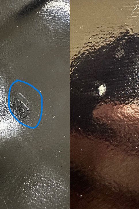 Close-up of ACQUO of Sweden black rubber boot surface with visible scratches, dents, and material imperfections