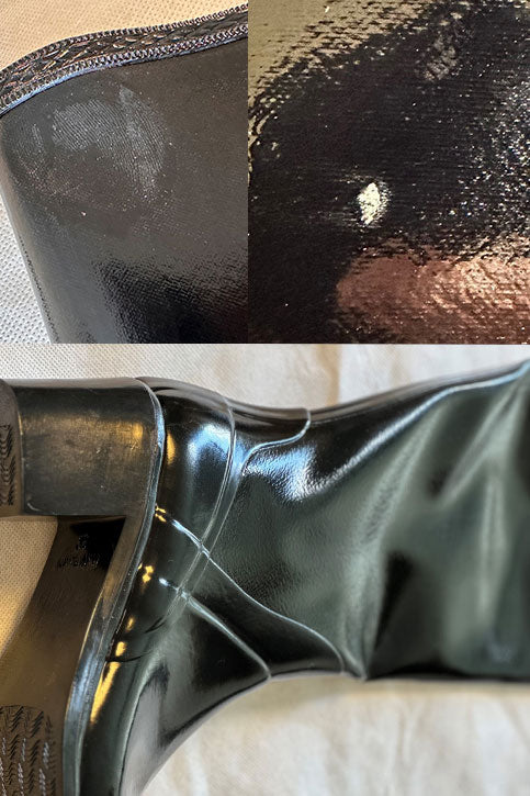 Close-up of ACQUO of Sweden black rubber boot surface showing scuff marks, dents, scratches, and visible wrinkles in the material.