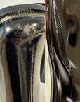 Close-up of ACQUO of Sweden black rubber boots showing surface defects, scratches, and imperfections