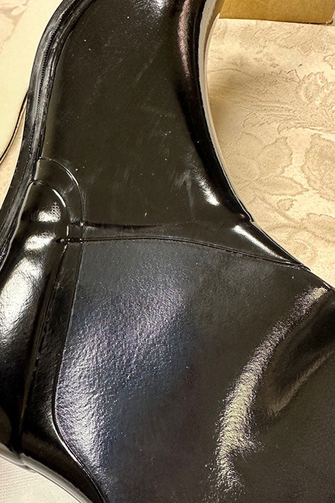 Detailed close-up of ACQUO of Sweden's black over-the-knee rubber boot showcasing the side panel construction, seam finishing, and subtle material texture for quality inspection and product documentation