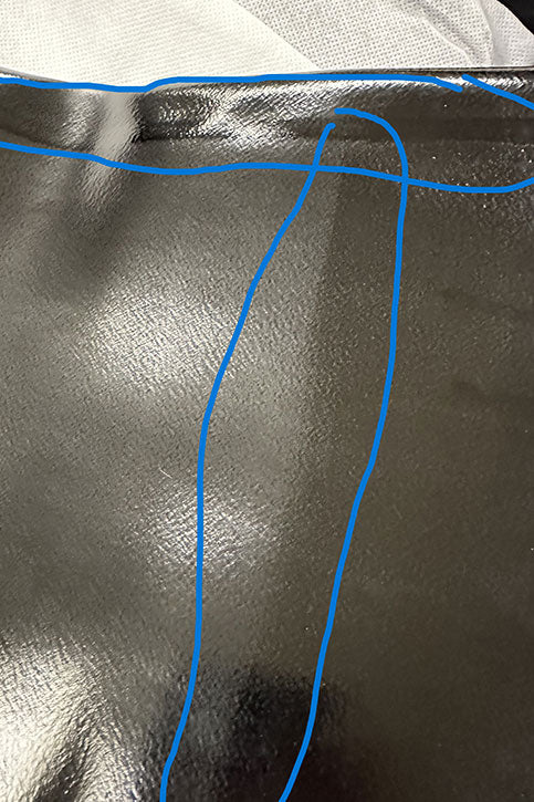 Detailed image of ACQUO of Sweden’s black over-the-knee rubber boots highlighting surface texture and marked material irregularities—showcasing handcrafted quality and rubber craftsmanship