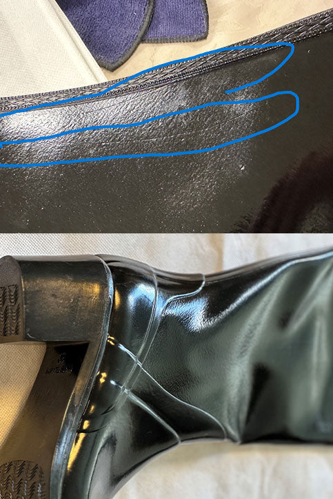 Detailed inspection of black glossy ACQUO of Sweden over the knee boots, showcasing light surface marks and creases on the shaft and heel area, emphasizing the handcrafted rubber boot quality and finish