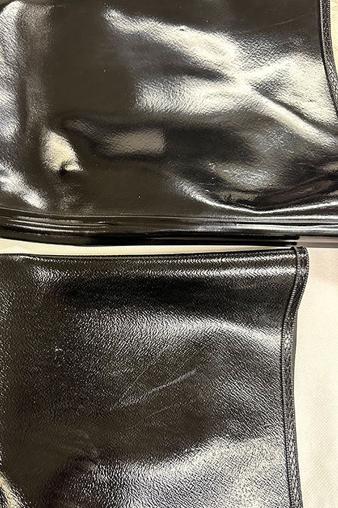 Close-up of ACQUO of Sweden boot shaft in shiny black natural rubber, showing surface defects and irregular finish