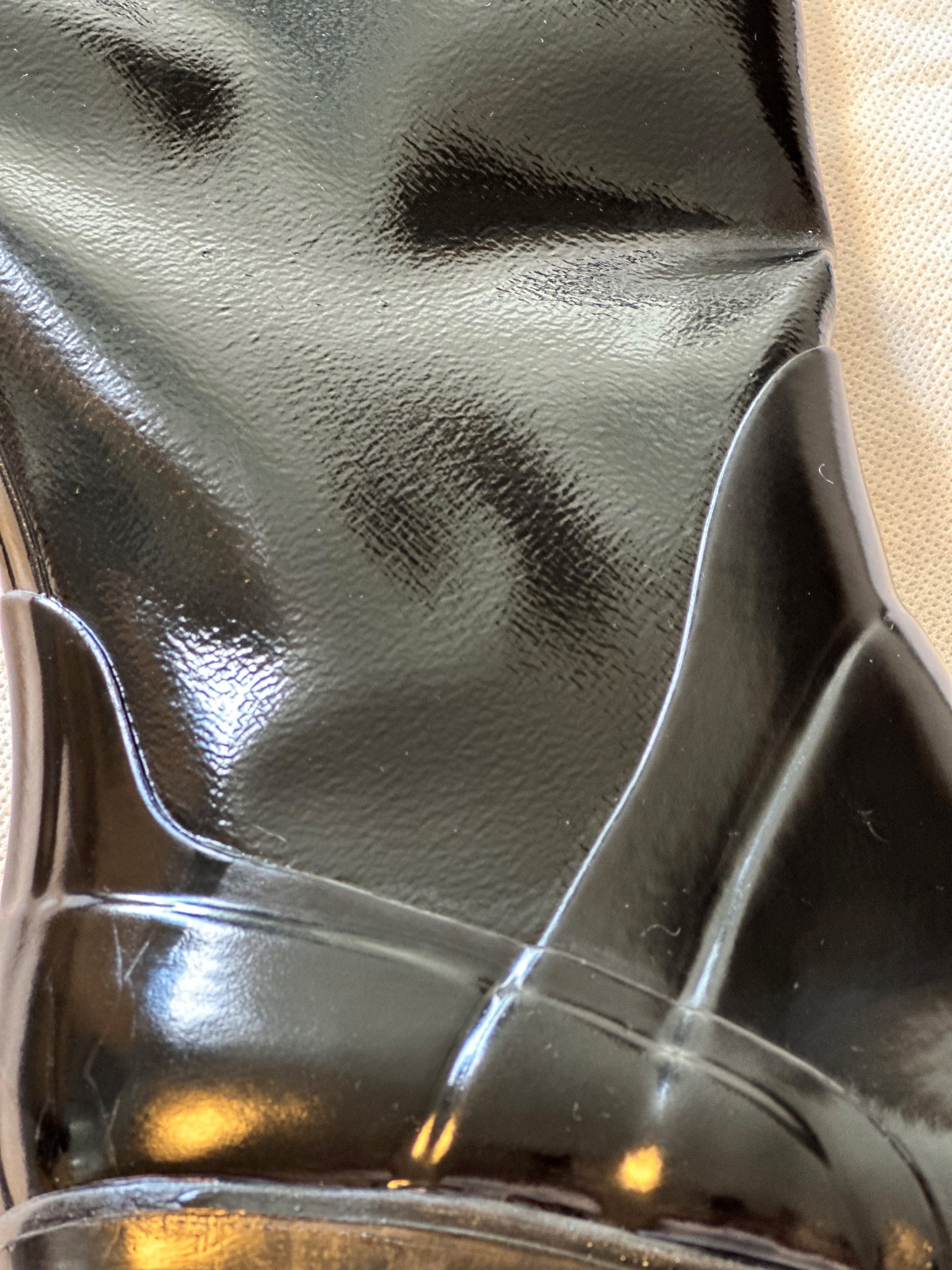 Close-up of the high-gloss finish and sculpted detailing on ACQUO of Sweden's black rubber boots, highlighting the premium craftsmanship and texture of the iconic Swedish boot design."